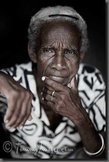 Trinidad, Cuba - An elderly Cuban woman with white hair looks on pensively.